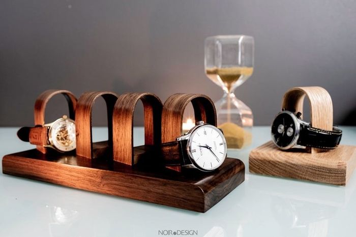 Two watches displayed on the watch organizer with empty spaces for two more watches