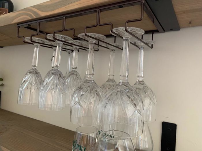 Metal wire frame holding wine glasses upside down
