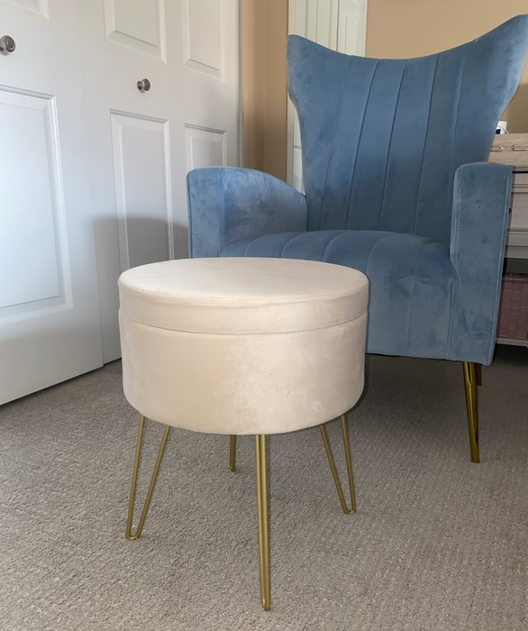 reviewer's cream-colored ottoman placed in front of a blue accent chair