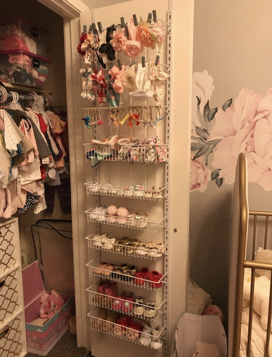 Reviewer's over-the-door storage holds baby clothes and accessories