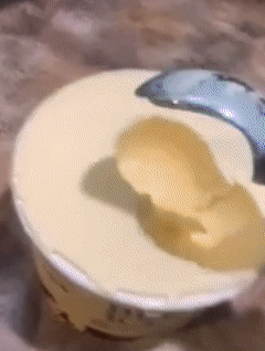 Reviewer smoothly scooping ice cream from the pint with ease
