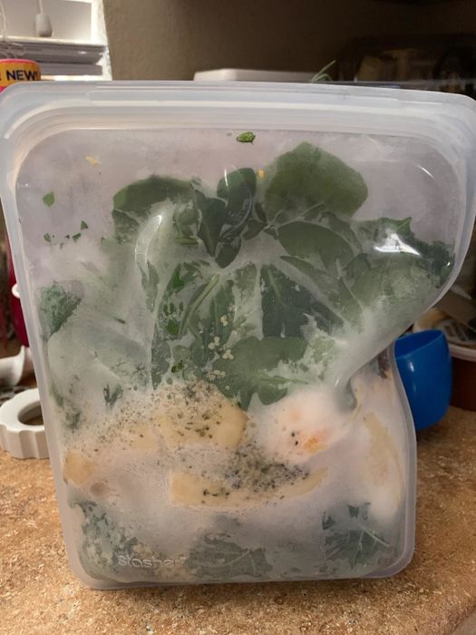 A silicone storage bag filled with smoothie ingredients, just taken out of the freezer
