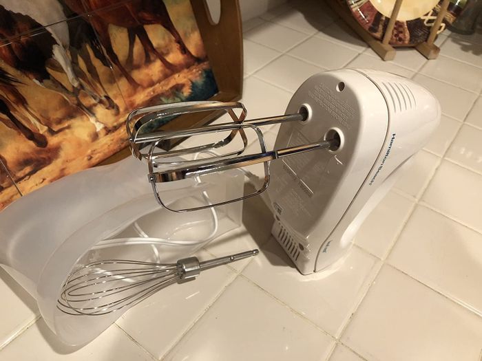The hand mixer, equipped with two beaters and a whisk
