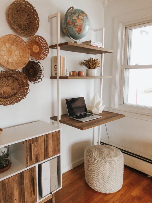 reviewer's rustic oak and white desk set up in a small office