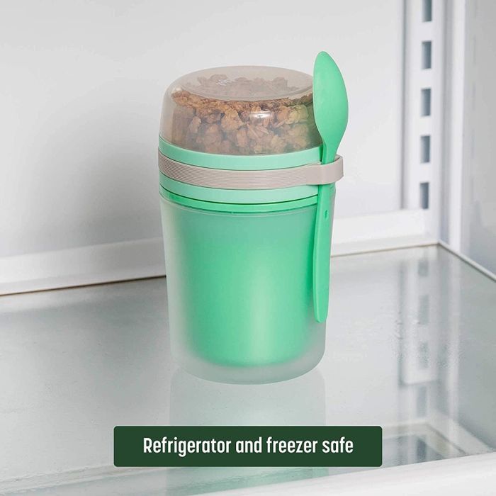 the green yogurt container with an attached green spoon and a clear top compartment for toppings