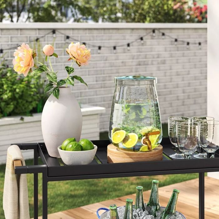 A plastic beverage pitcher being served at an outdoor event.