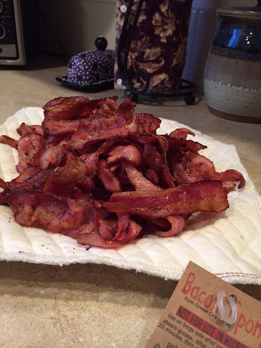 A pile of bacon resting on the reusable towel.