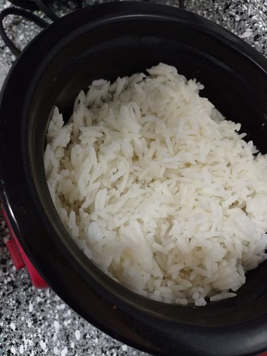 A reviewer's photo of perfectly cooked rice from the Dash mini rice cooker in red.