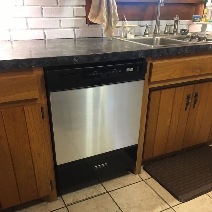 The same dishwasher now covered with stainless-steel contact paper as shown by the reviewer