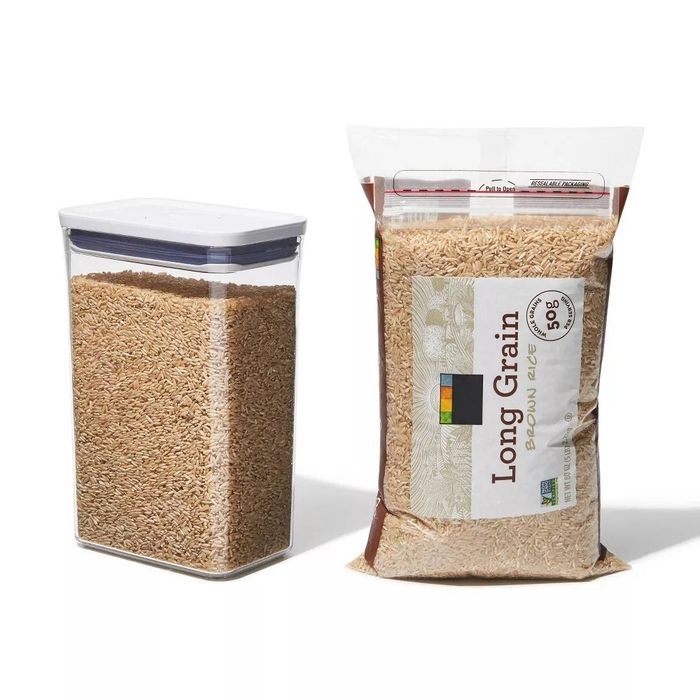 A container filled with a bag of long rice.