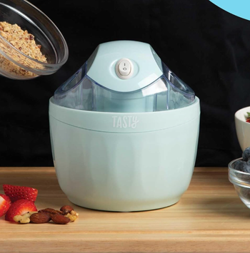 A light blue Tasty brand ice cream maker, ready to create sweet treats.