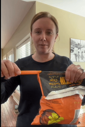 A reviewer using a Gripstic to seal a chip bag and turning it upside down