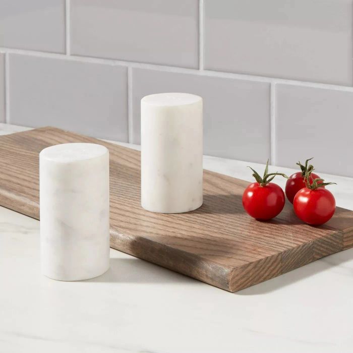 A salt and pepper shaker set resting in a kitchen space.