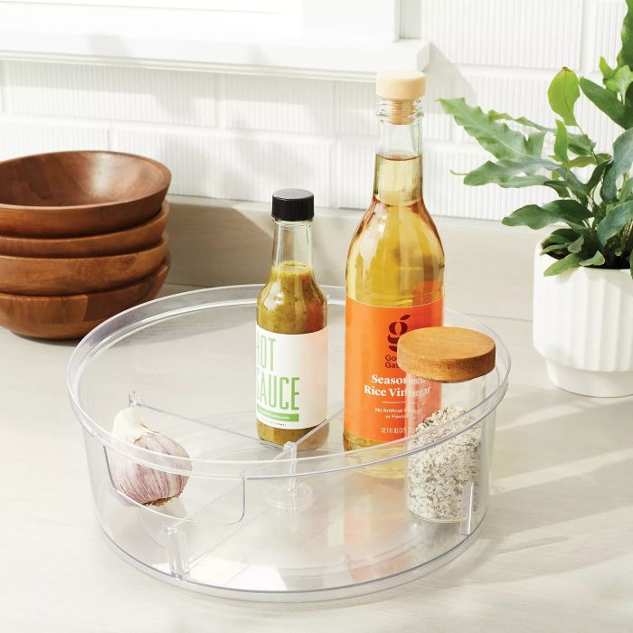 A rotating turntable with various compartments holding an assortment of condiments.