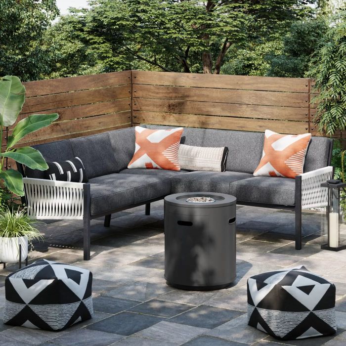 A black fire column set up in a backyard, creating a cozy atmosphere