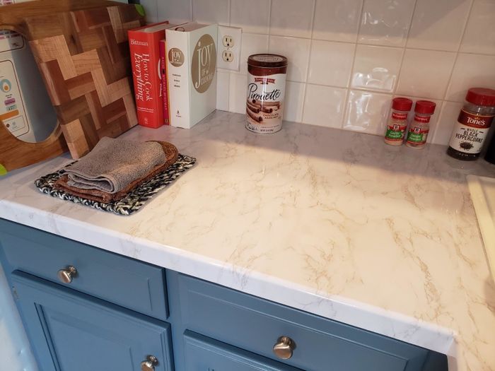 Reviewer's kitchen countertop shown with the contact paper successfully installed, giving it a fresh look