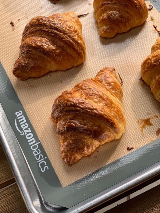 A reviewer's croissants baking on a sheet pan