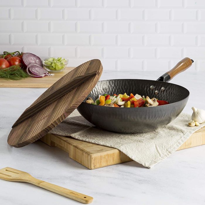 the textured wok featuring a wooden lid