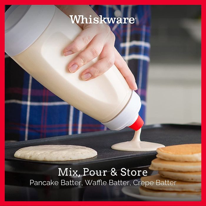 A model pouring pancake batter from the Whiskware Pancake Batter Mixer with the BlenderBall Wire Whisk inside.