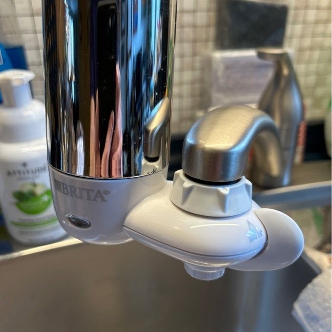A Brita water filter attached to a kitchen faucet, ensuring clean and purified drinking water.