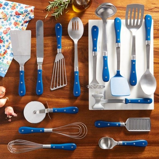 A full set of blue utensils arranged on a kitchen table