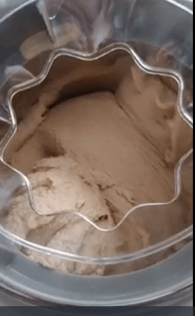 A gif of the reviewer showing ice cream being churned in the machine.