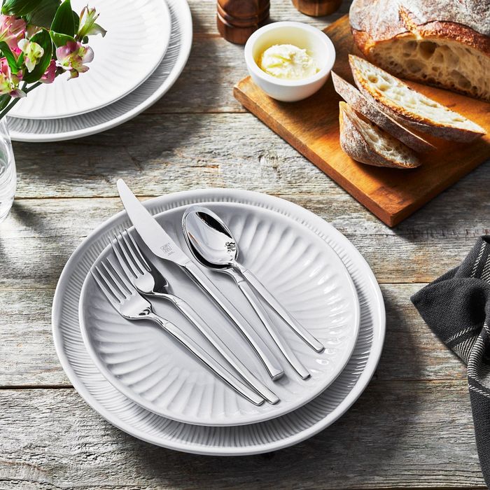 A set of stainless steel flatware neatly arranged on a plate.