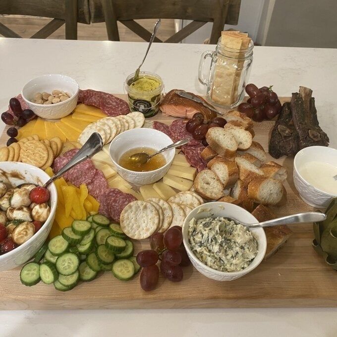 Review image of the board being used as a charcuterie platter