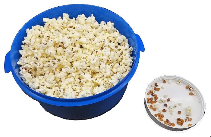 The blue bowl with the removable tray filled with the unpopped kernels that have been sifted out.