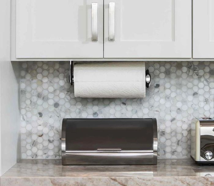 A photo of the paper towel holder mounted underneath kitchen cabinets