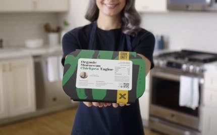 A woman holds a package labeled