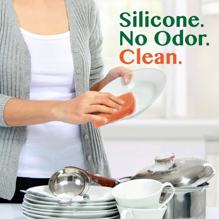 A model using the silicone sponge on a dish with the caption 'silicone. no odor. clean.'