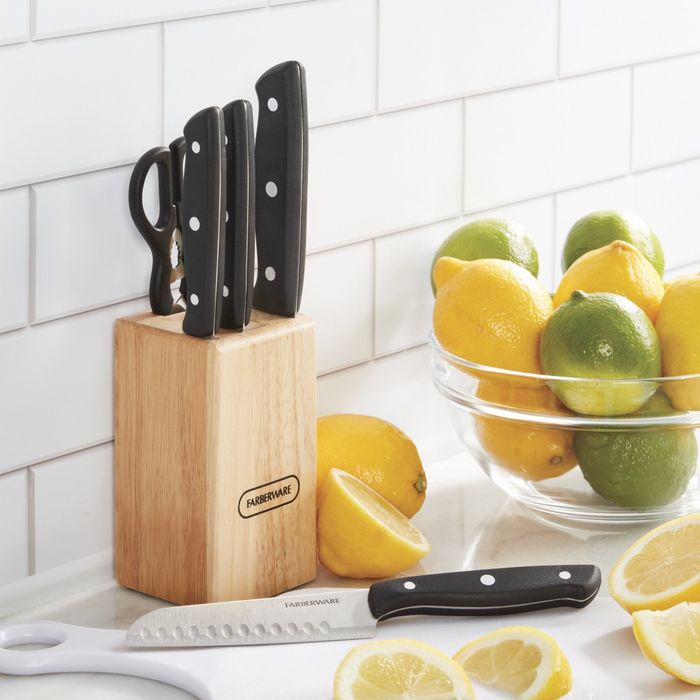 A knife set displayed in a wooden block on a kitchen counter