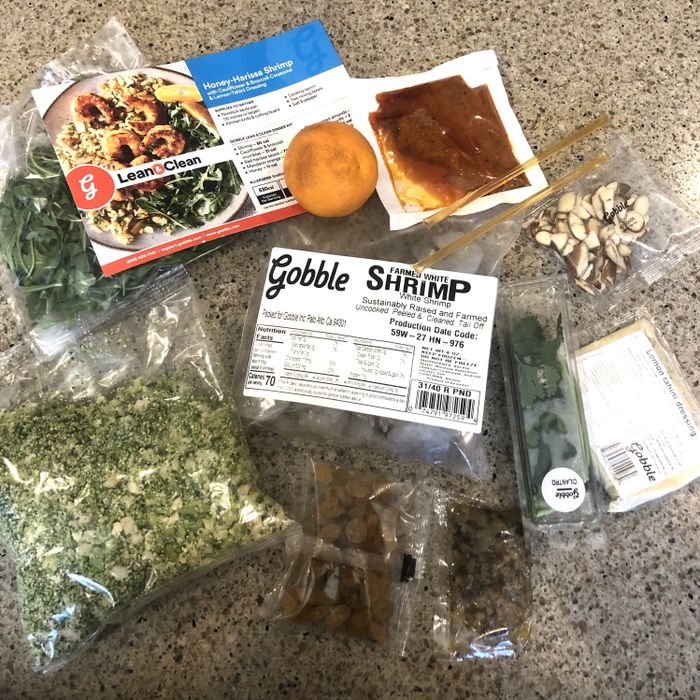 An assortment of ingredients for making the Honey Harissa Shrimp from the Gobble meal kit, ready for cooking.