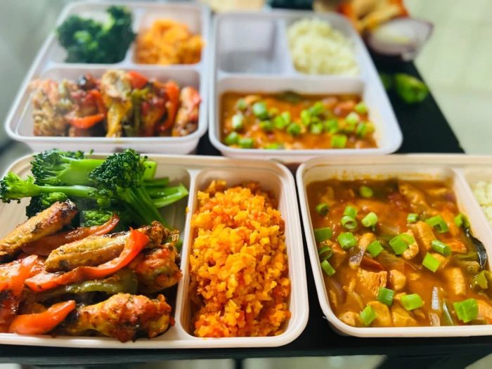 A collection of meal prep containers filled with an assortment of healthy foods, including vibrant vegetables and lean proteins, ready for the week ahead.