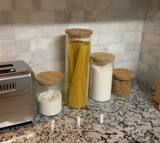 The canister set filled with ingredients on a countertop