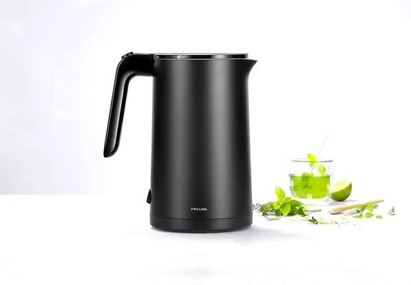A black electric kettle, offering efficient and quiet water boiling with a timeless design.