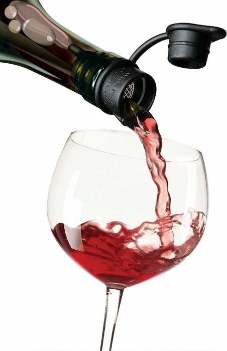Wine being poured from a bottle through the aerating stopper into a glass.