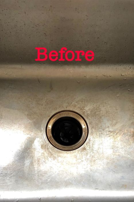 A review image showing a stained stainless steel sink before using the cleaner.