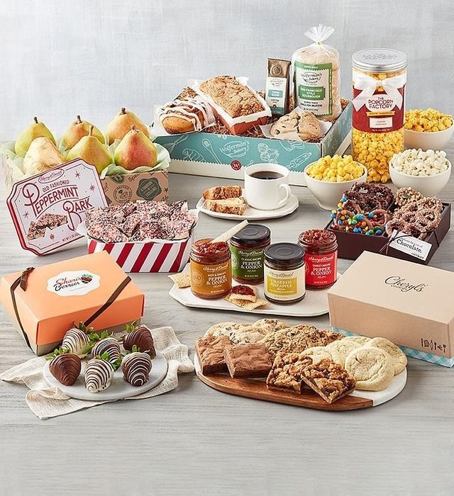 A variety of gourmet gift baskets filled with snacks, chocolates, popcorn, and preserves.