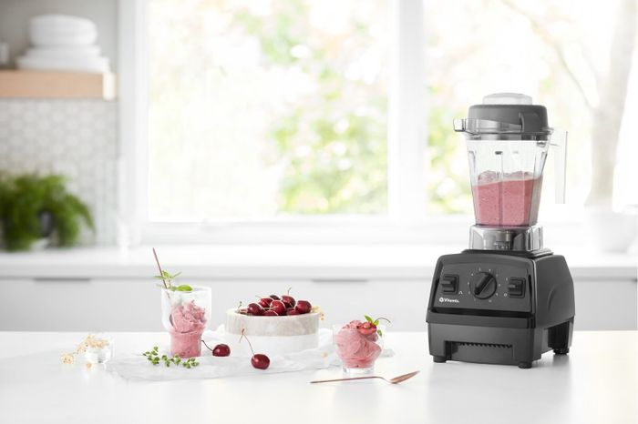 The Vitamix blender placed on a counter with a fresh smoothie in the pitcher