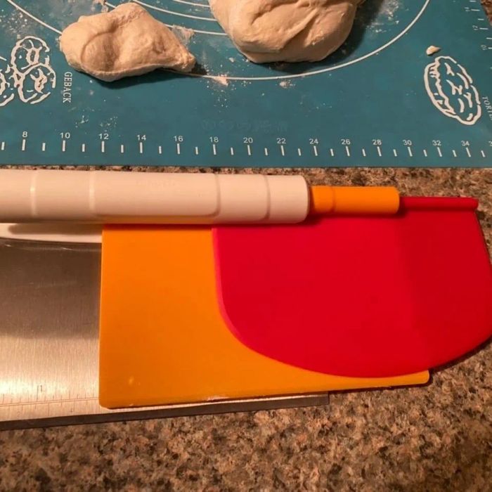 Baking tools, including a dough scraper and chopper, placed on a counter