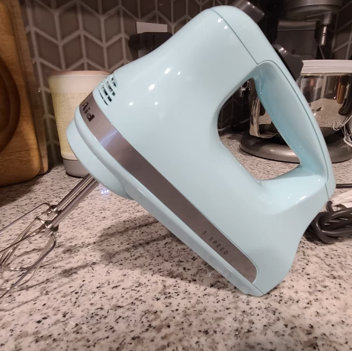 A light blue hand mixer, perfect for quick and easy baking.