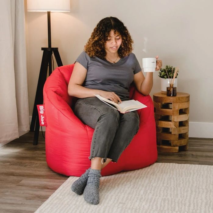 Person lounging on a red bean bag chair