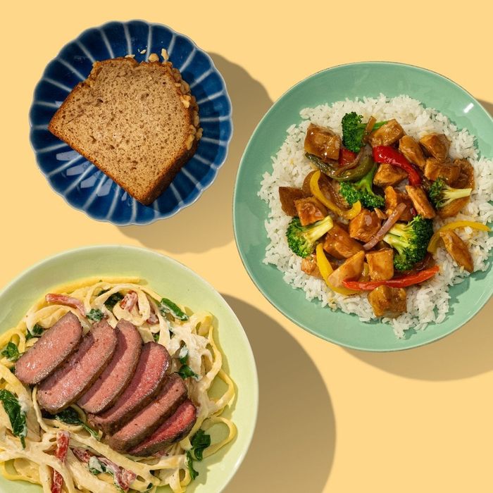 Three plates of food: a slice of banana bread, a rice dish featuring chicken and vegetables, and a pasta dish topped with steak slices.