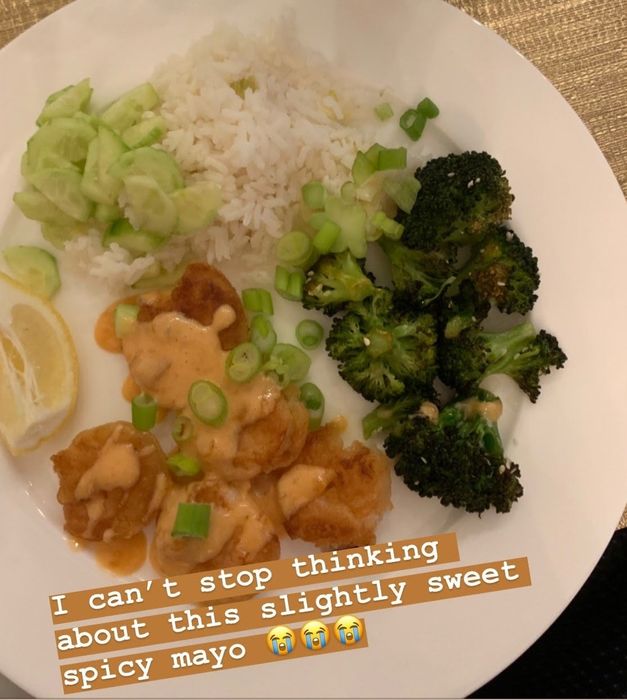 Mytour editor's plate featuring a combination of broccoli, rice, and shrimp drizzled with sauce, captioned