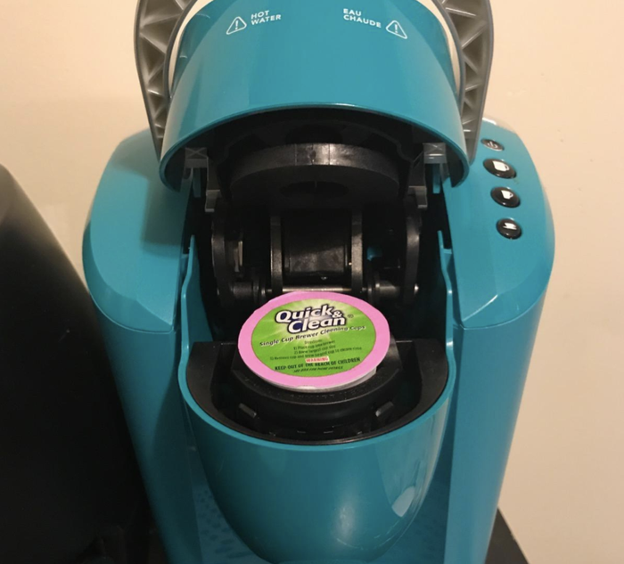 A review image showing a cleaning K-Cup being placed inside a Keurig machine.