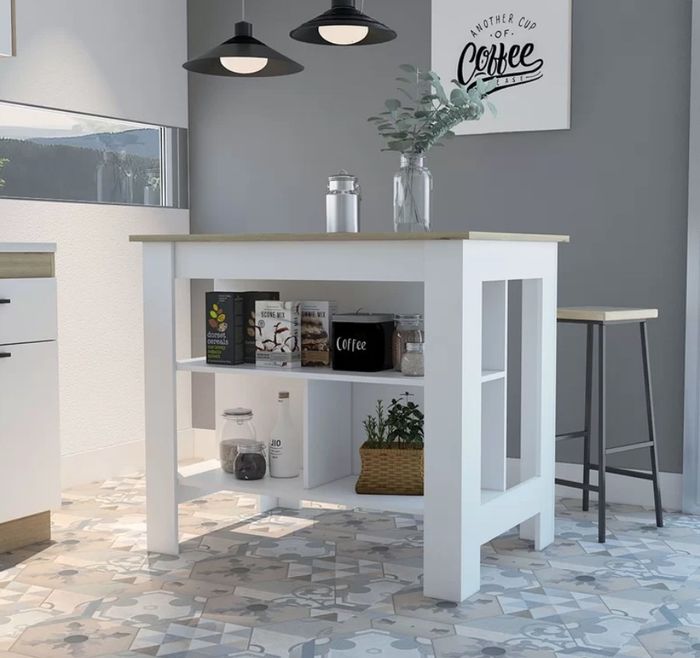 A white kitchen island with a wooden table top, shelving below, and a bar stool