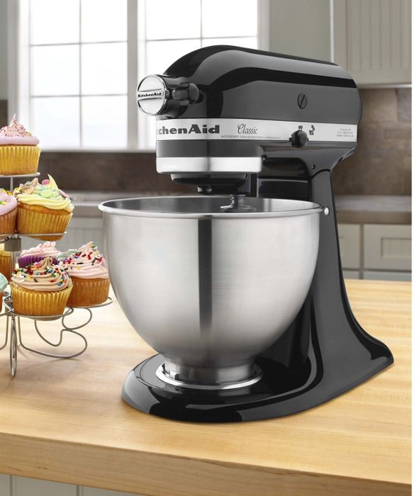 A KitchenAid mixer with a large bowl placed on a kitchen counter
