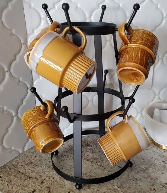 A photo from a reviewer showing mugs hanging neatly on the mug tree